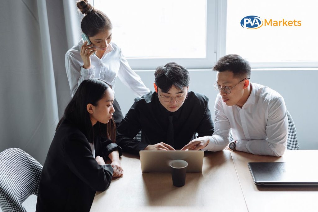 Business team planning LinkedIn outreach campaigns on laptops